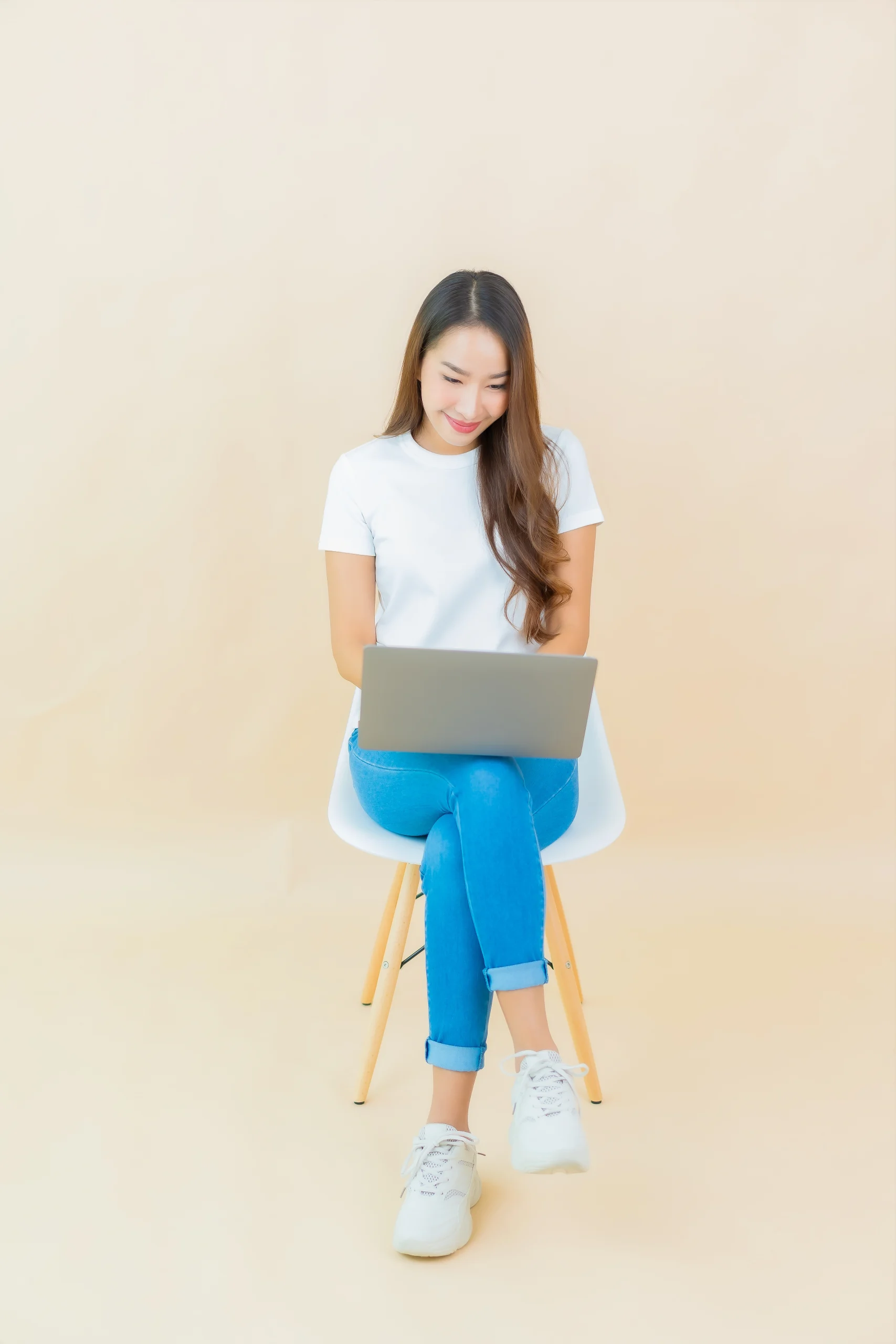 asian woman use computer laptop beige scaled